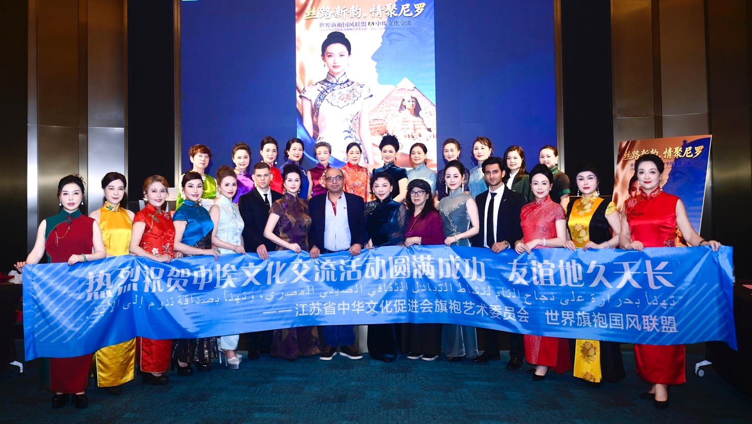 A group of people holding a blue banner
Description automatically generated